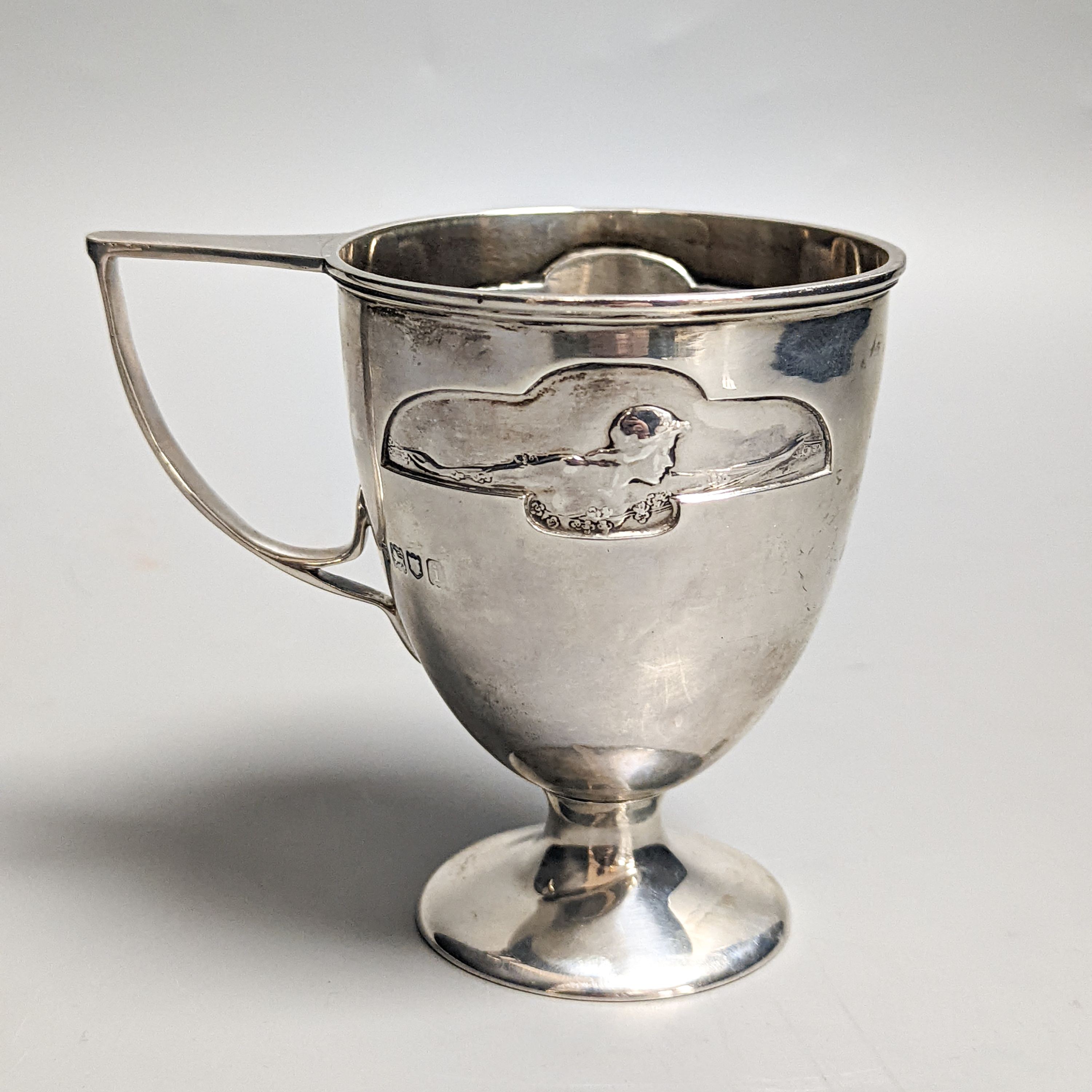 An Edwardian Art Nouveau silver pedestal christening mug, by William Hutton & Sons, London, 1904, 97mm, 138 grams.
